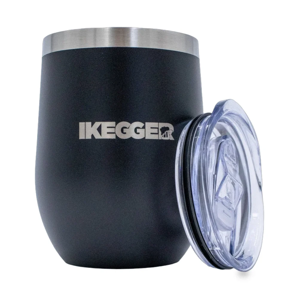 Close-up of a matte black cylindrical container with a brushed metal rim at the top and a clear plastic lid on the right; the word 'KEGGER' is partly visible on the side.